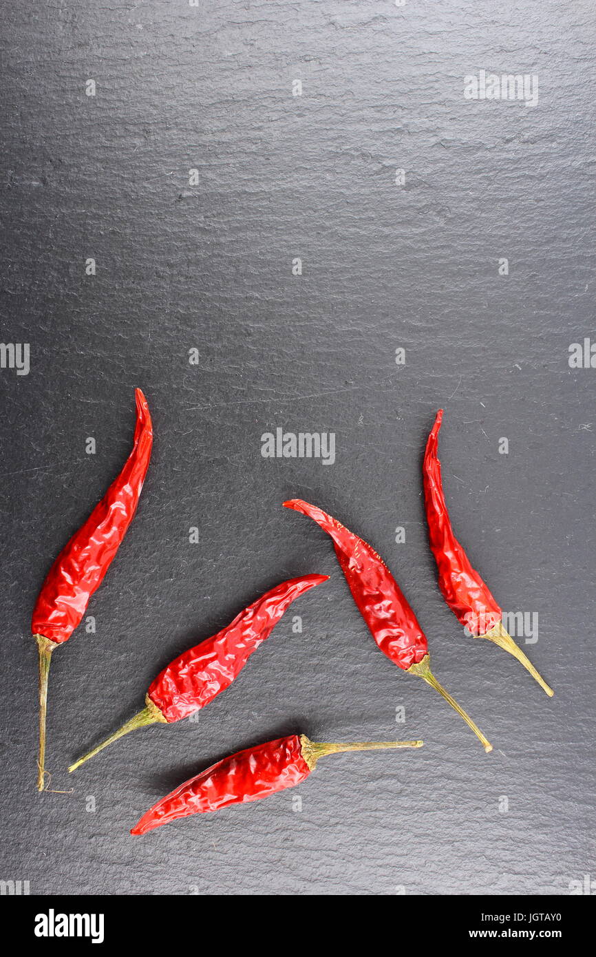 composition of dried thai chili peppers on a slate plate with copyspace