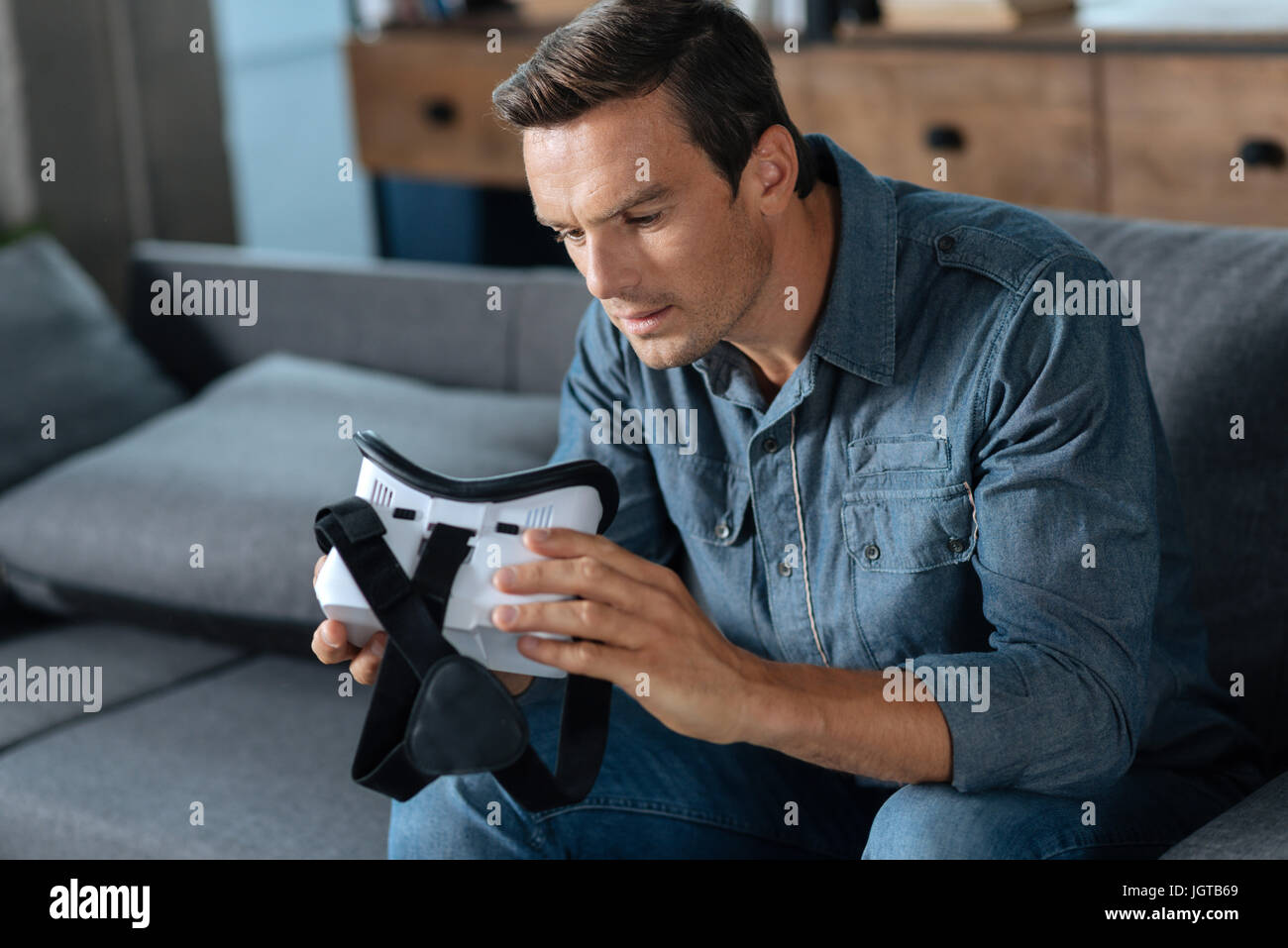 Intelligent guy figuring out how to use his new gear Stock Photo - Alamy