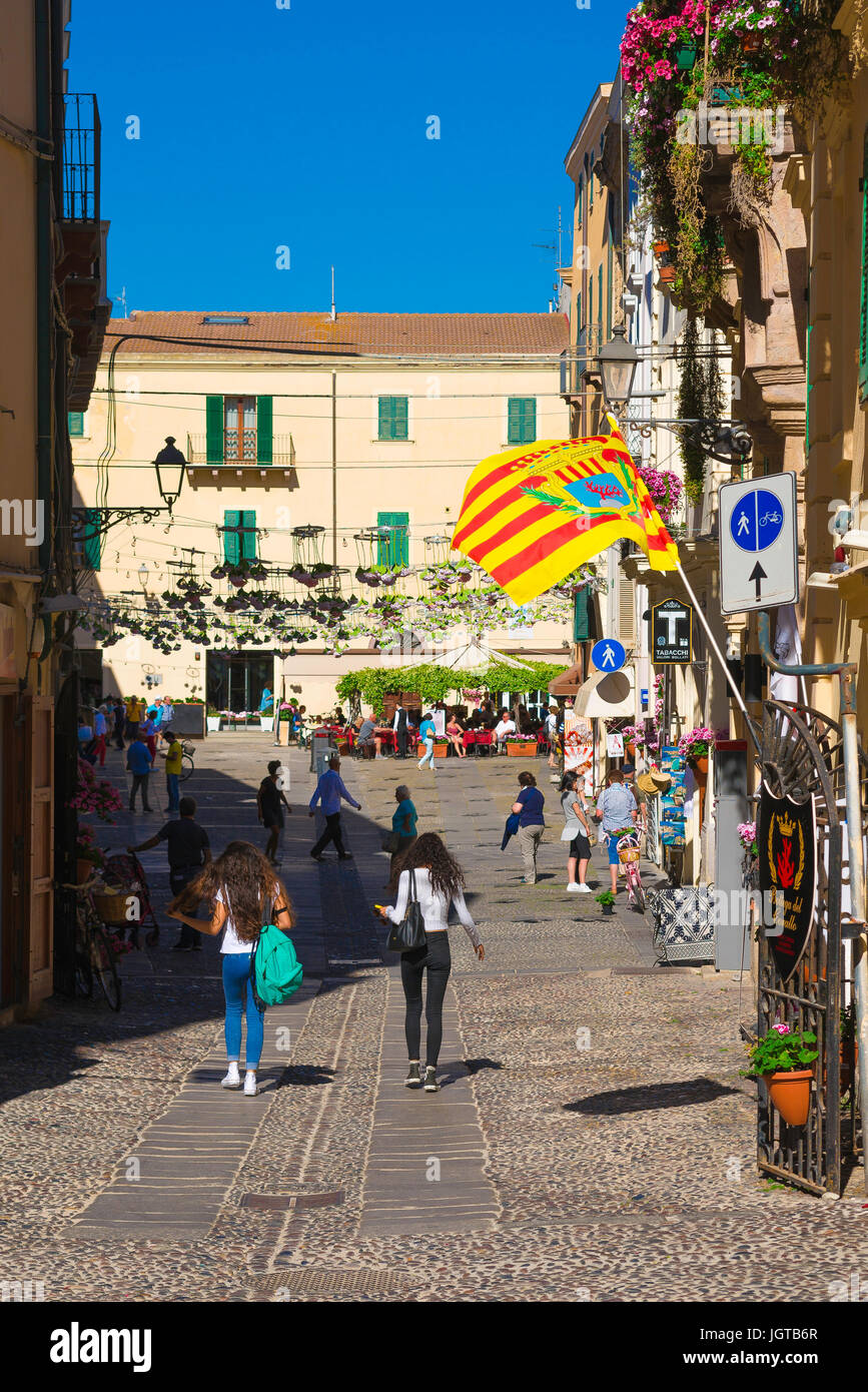Alghero Sardinia, people stroll through the Piazza Civica in the historic old town quarter of Alghero, Sardinia. Stock Photo