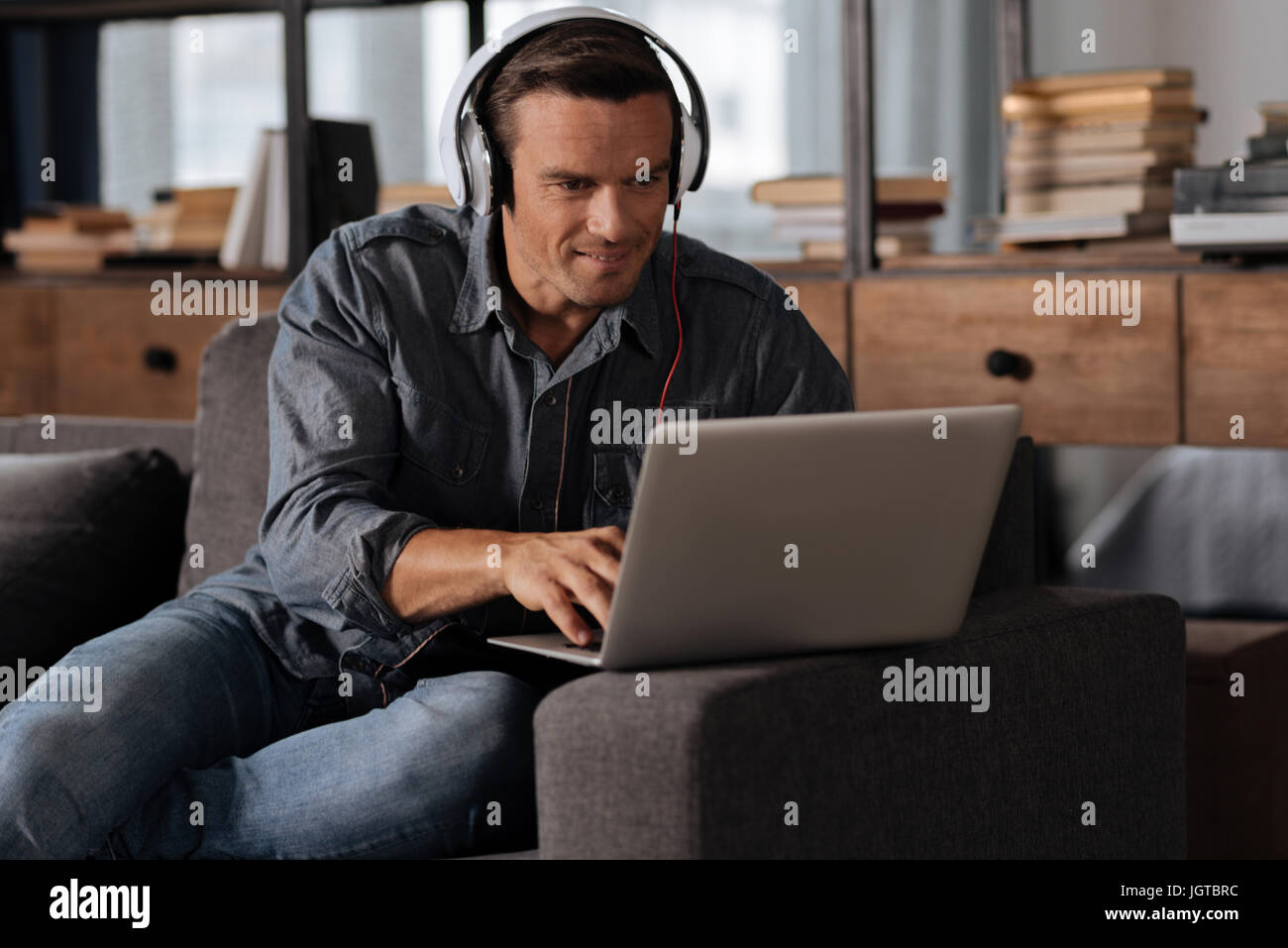 Smart savvy man working on his task at home Stock Photo