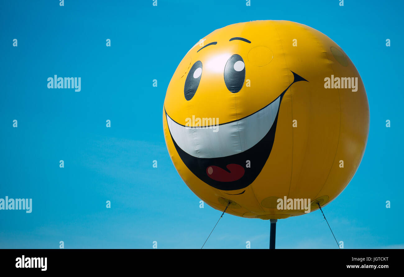 Large inflatable ball-smiley on the street. Stock Photo