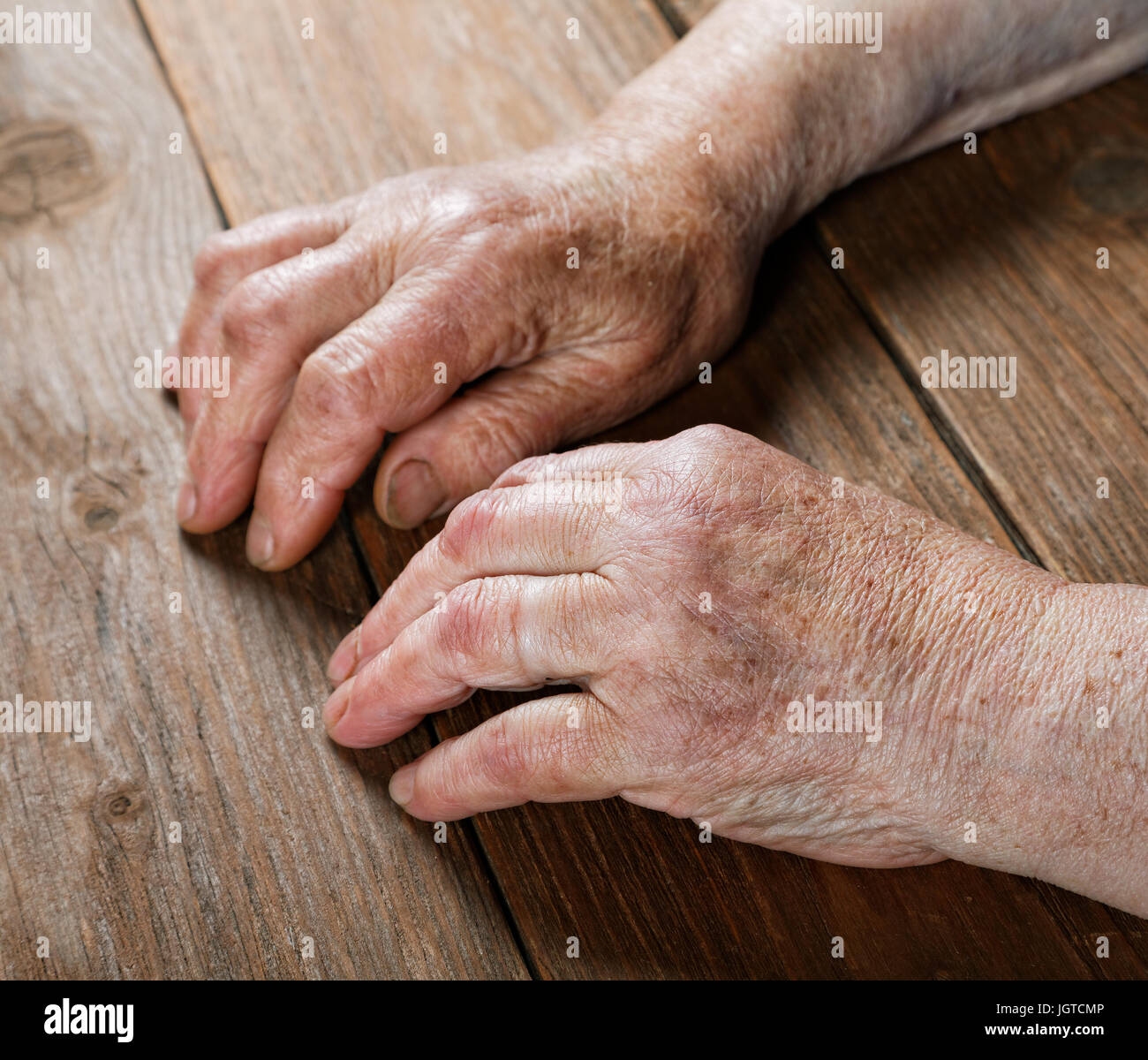 Hands of an old woman close-up on a table Stock Photo