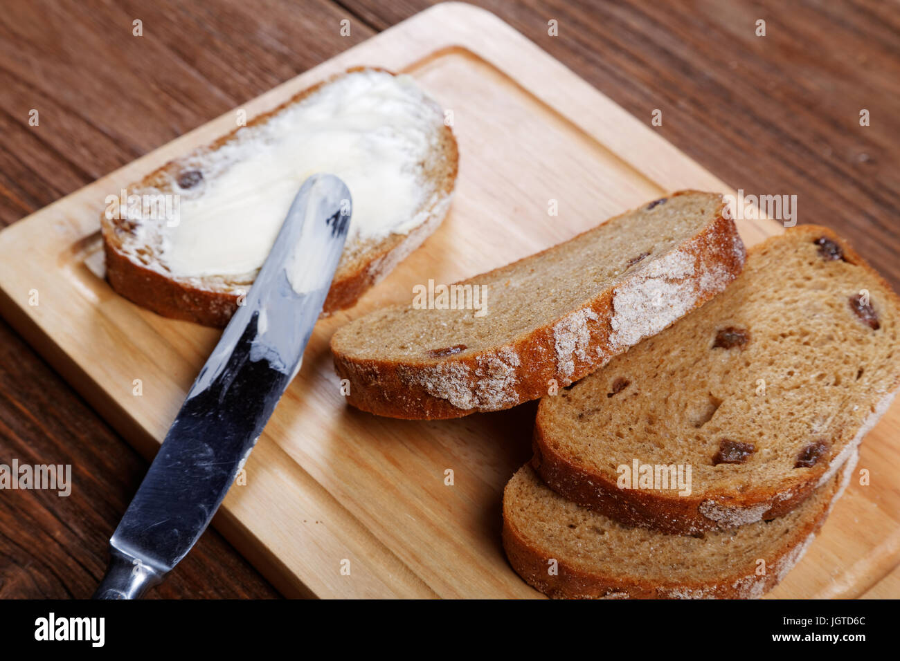 Sliced bread smeared with butter close-up Stock Photo