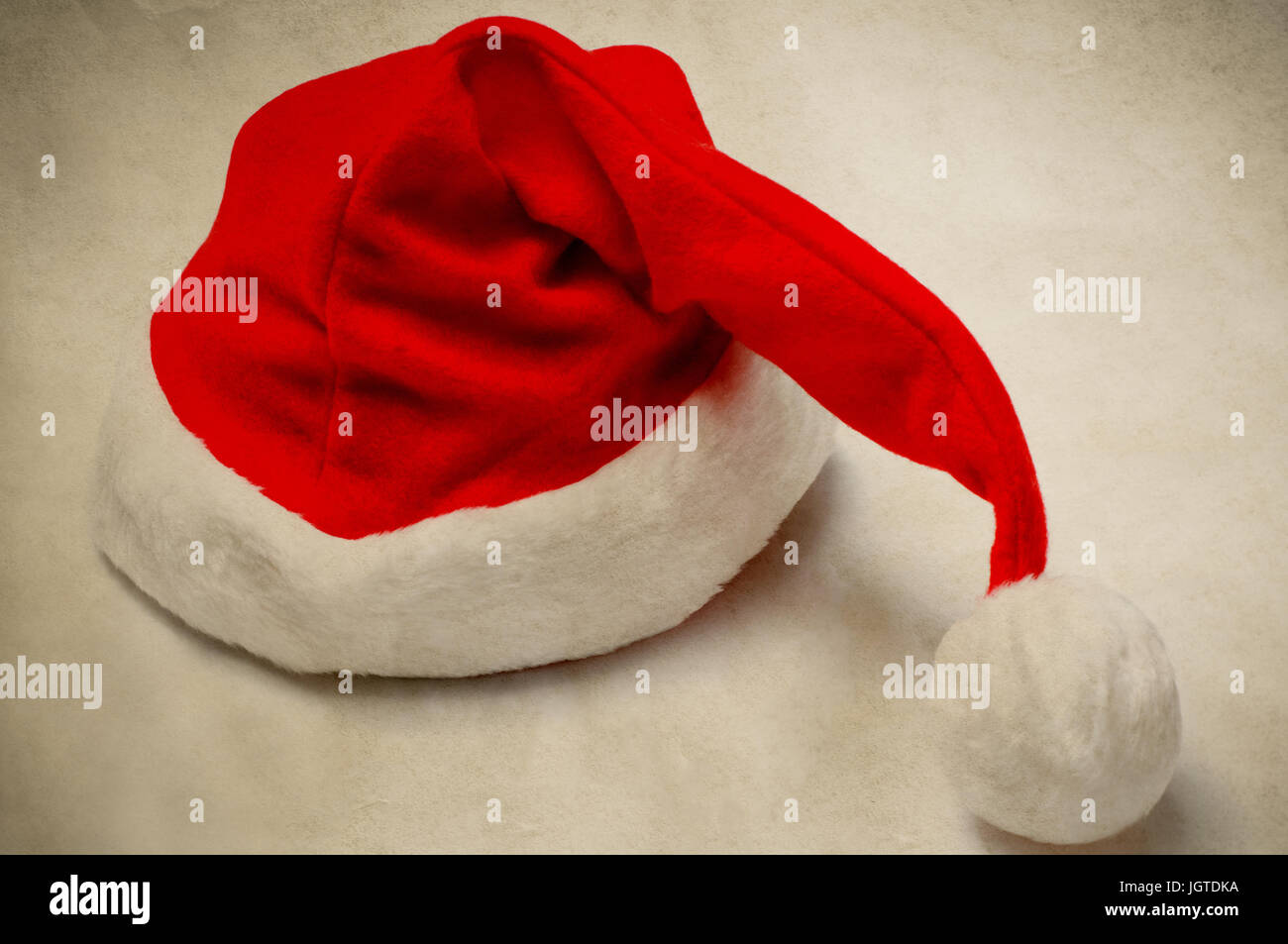 A Christmas Santa hat in vintage style on parchment like paper Stock ...