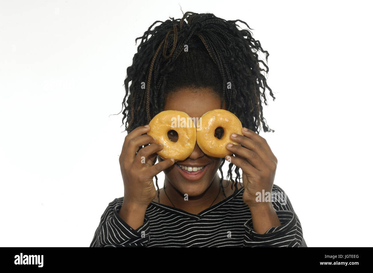Teenage girl playing with donuts Stock Photo
