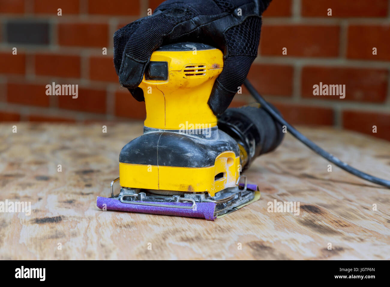 Home improvement - handyman sanding wood in workshop sand wood Stock Photo