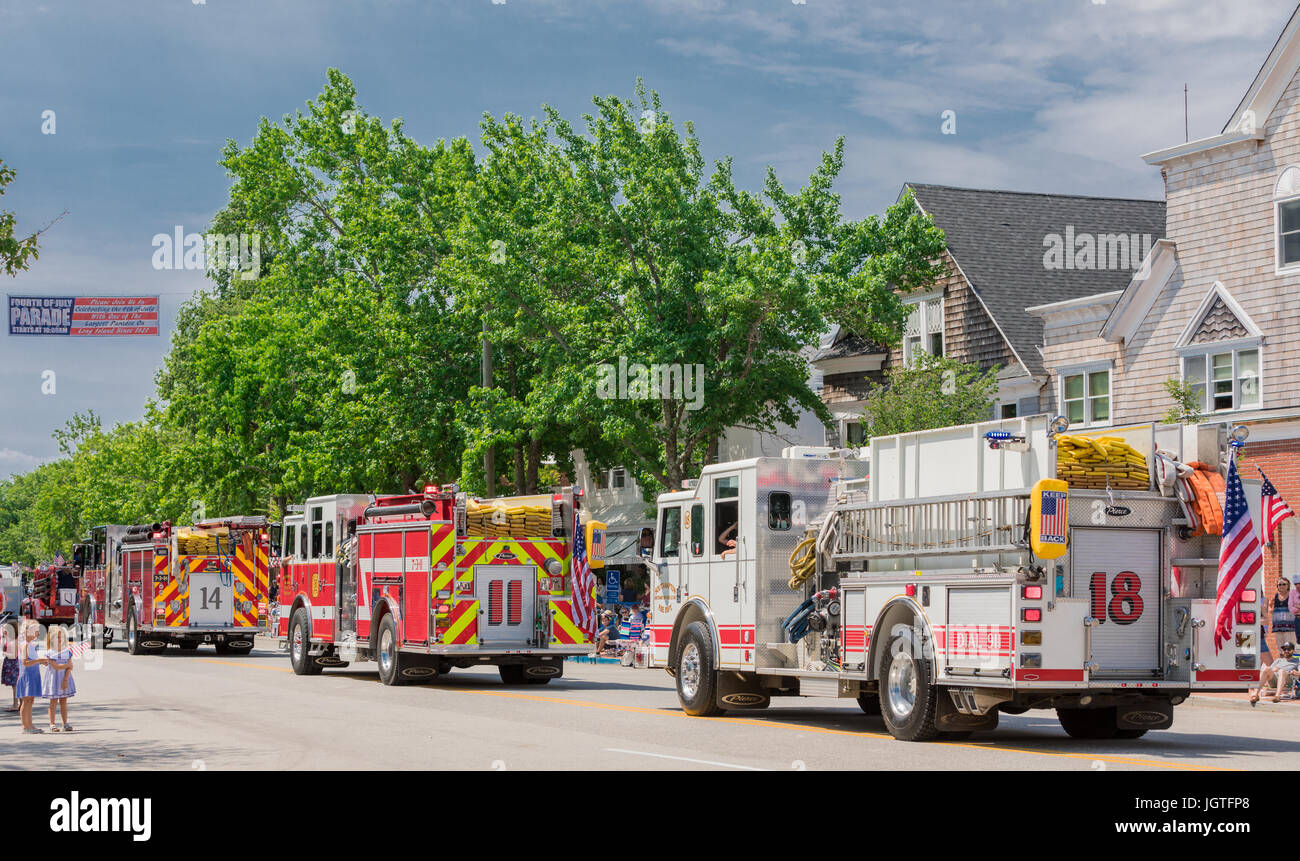 a line of local firetrucks in a fourth of july parade in Southampton