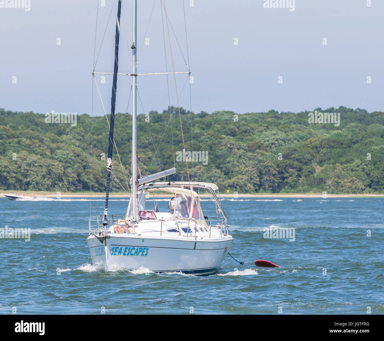sail boat off shelter island with sails down Stock Photo