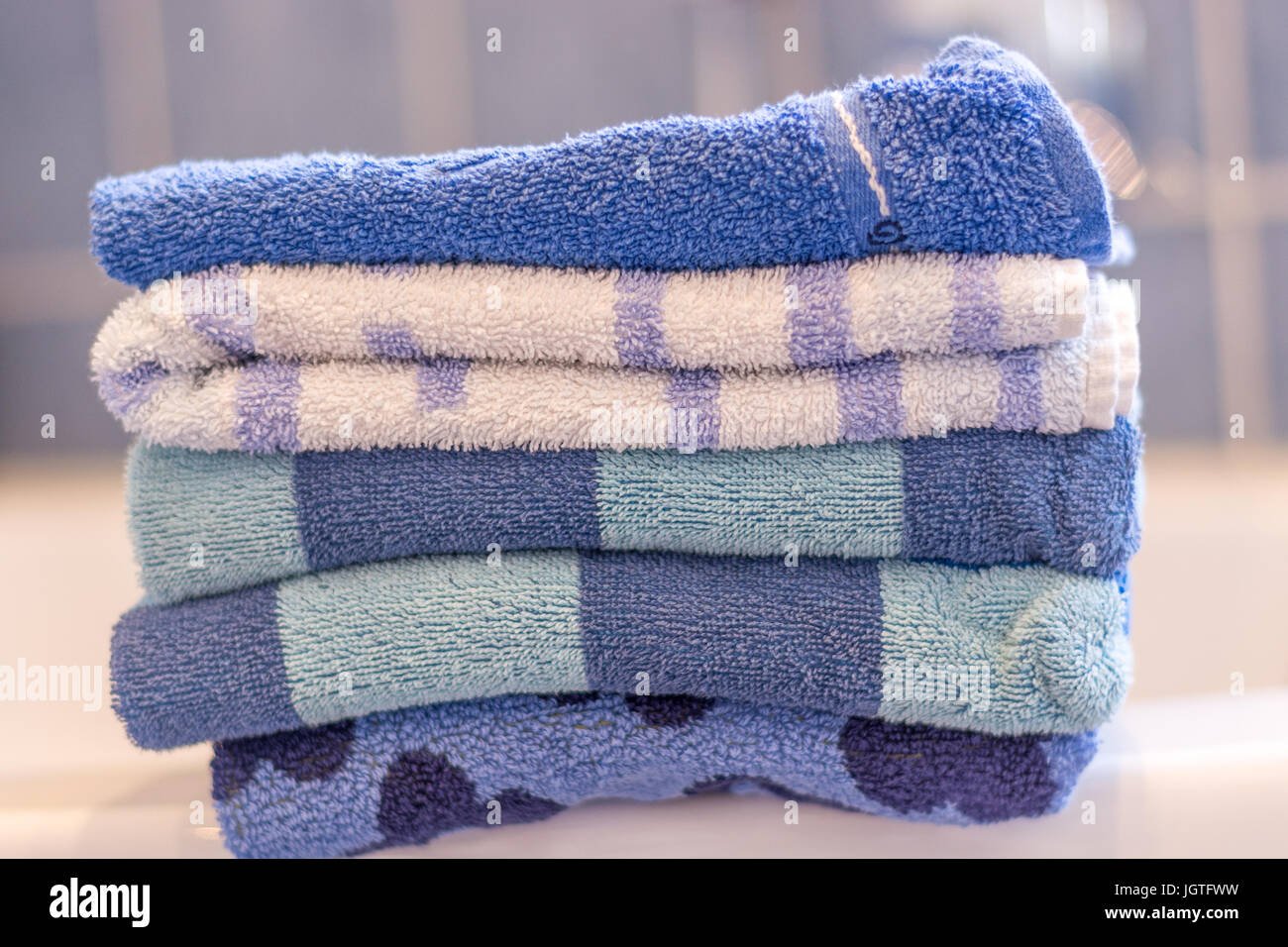 Several stacked blue towels in the bathroom close up Stock Photo Alamy