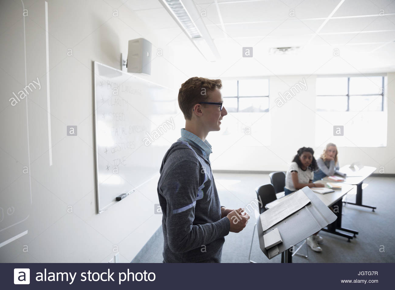 Boy middle school student speaking in debate club classroom Stock Photo