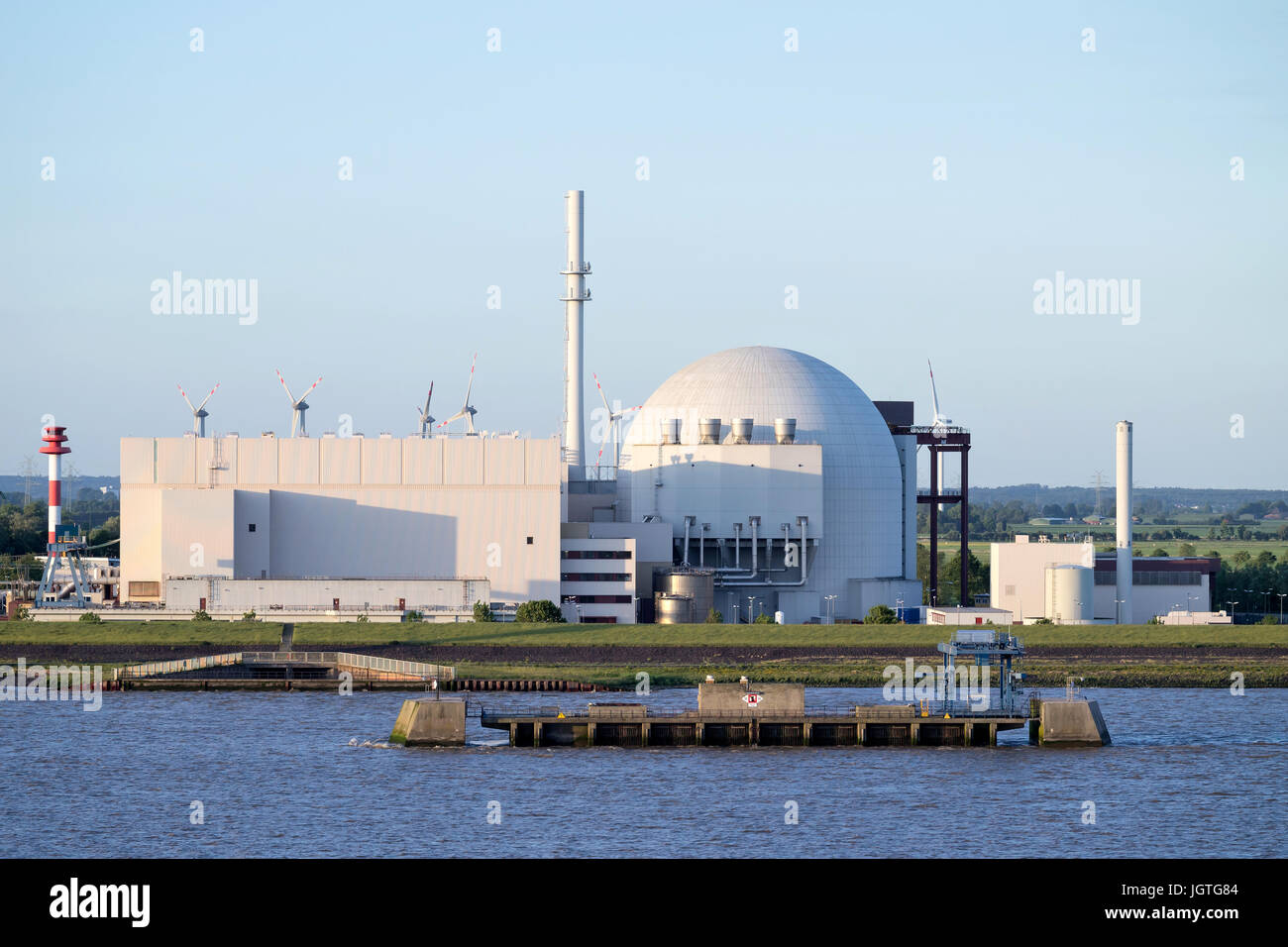 Riverside view of Brokdorf Nuclear Power Plant. It started in October 1986 and the decommissioning is planned for 2021. Stock Photo
