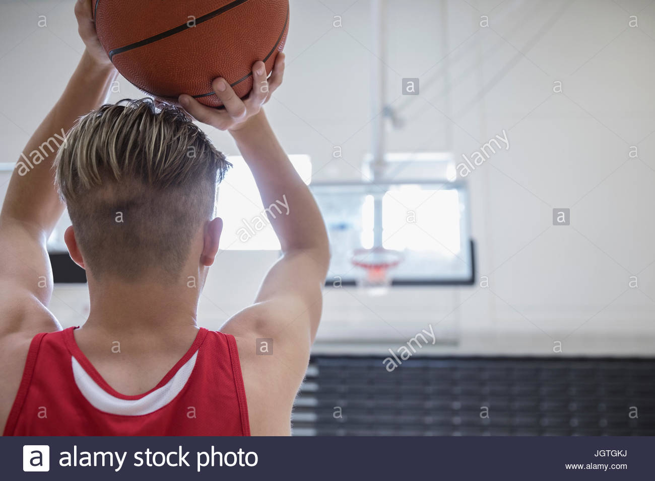 Male college basketball player shooting free throw in gymnasium Stock Photo Alamy