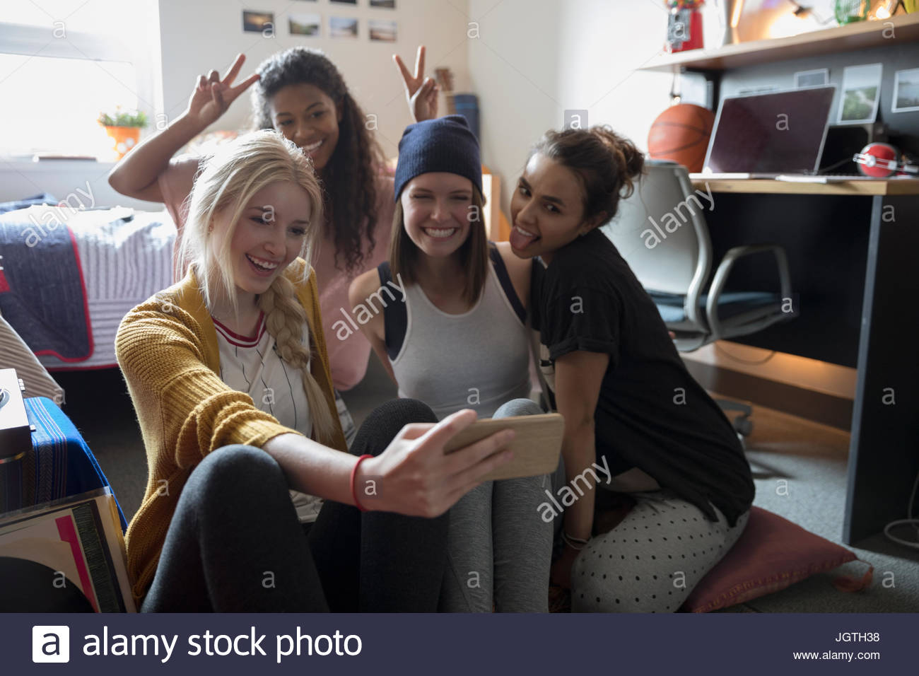 Playful Female College Student Friends Taking Selfie In Dorm