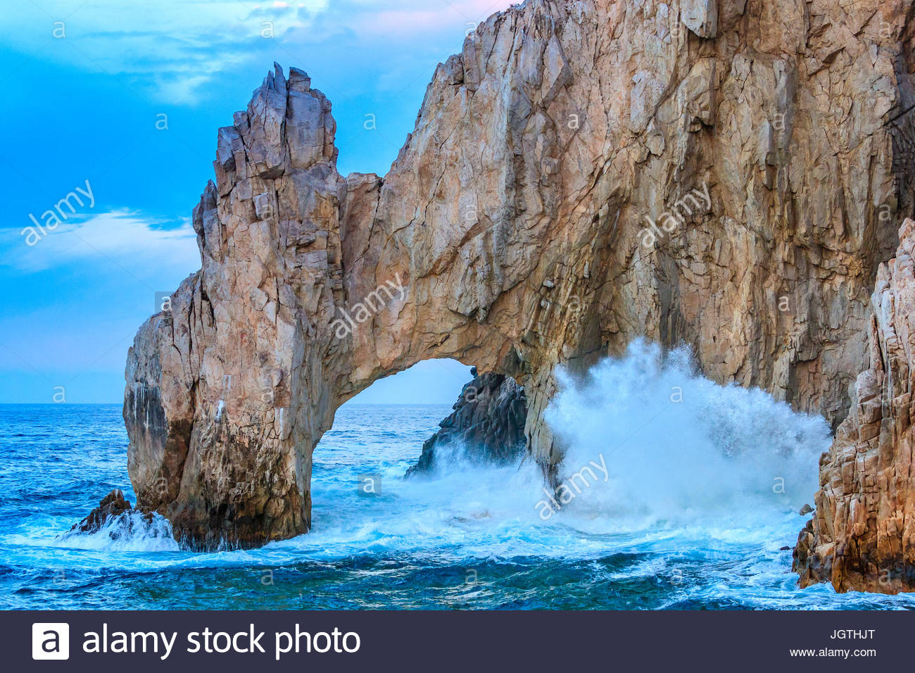 Waves crash against the rocks at the famous arch, Los Arcos at Lands End. Stock Photo