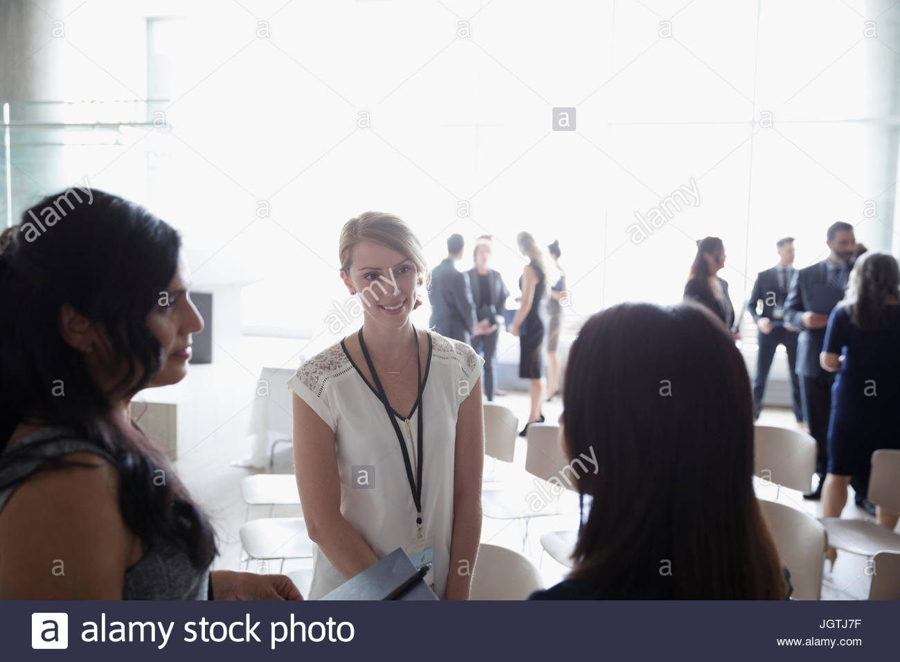 Businesswomen talking, networking at conference Stock Photo