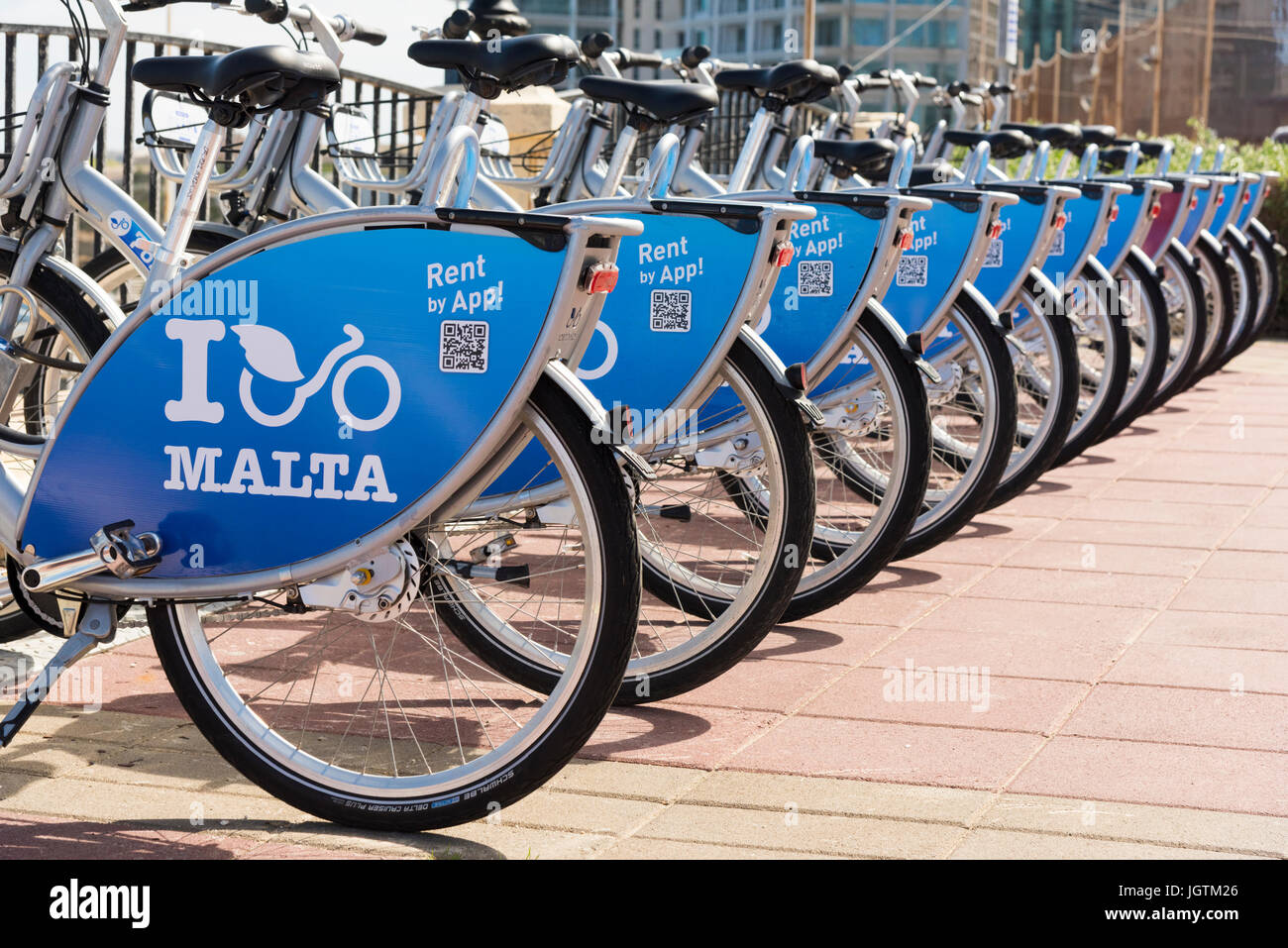 I Malta hire bicycles or bikes lined up in a cycle rack in Malta Stock Photo