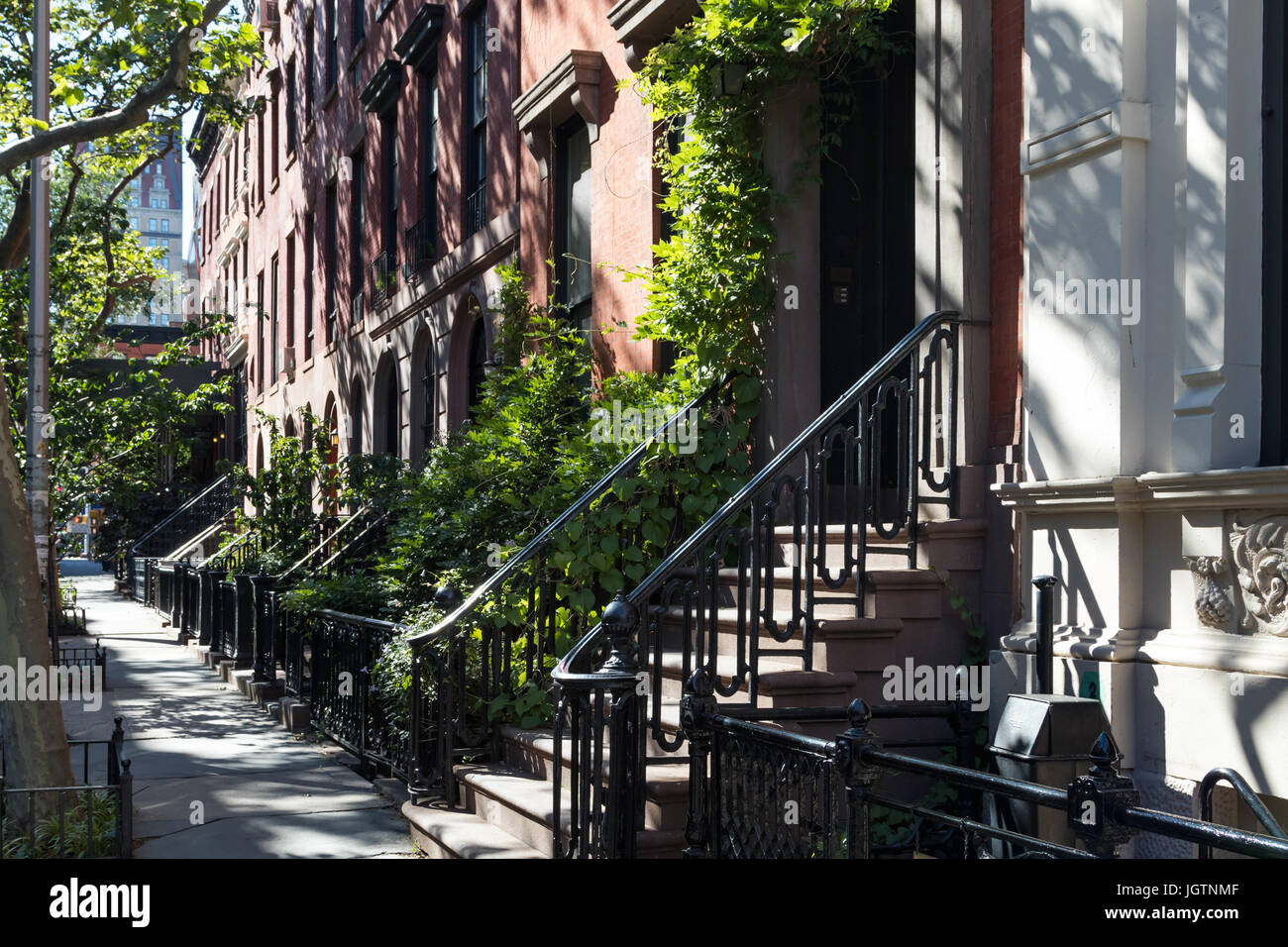 Empty sidewalk in front of historic brownstone buildings in the Gramercy Park neighborhood of Manhattan in New York City NYC Stock Photo