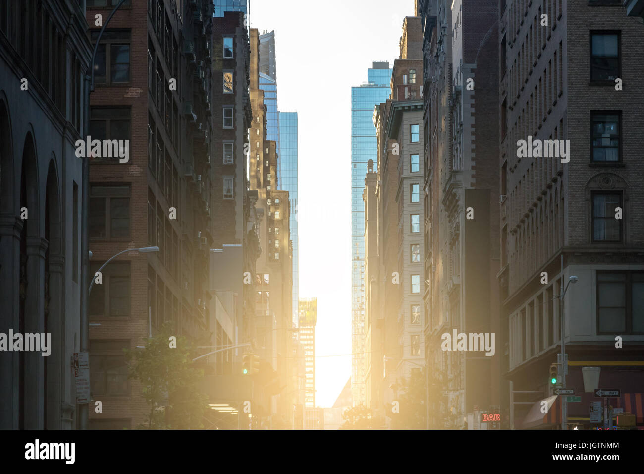 Sunlight shines down the crowded streets of New York City NYC Stock Photo