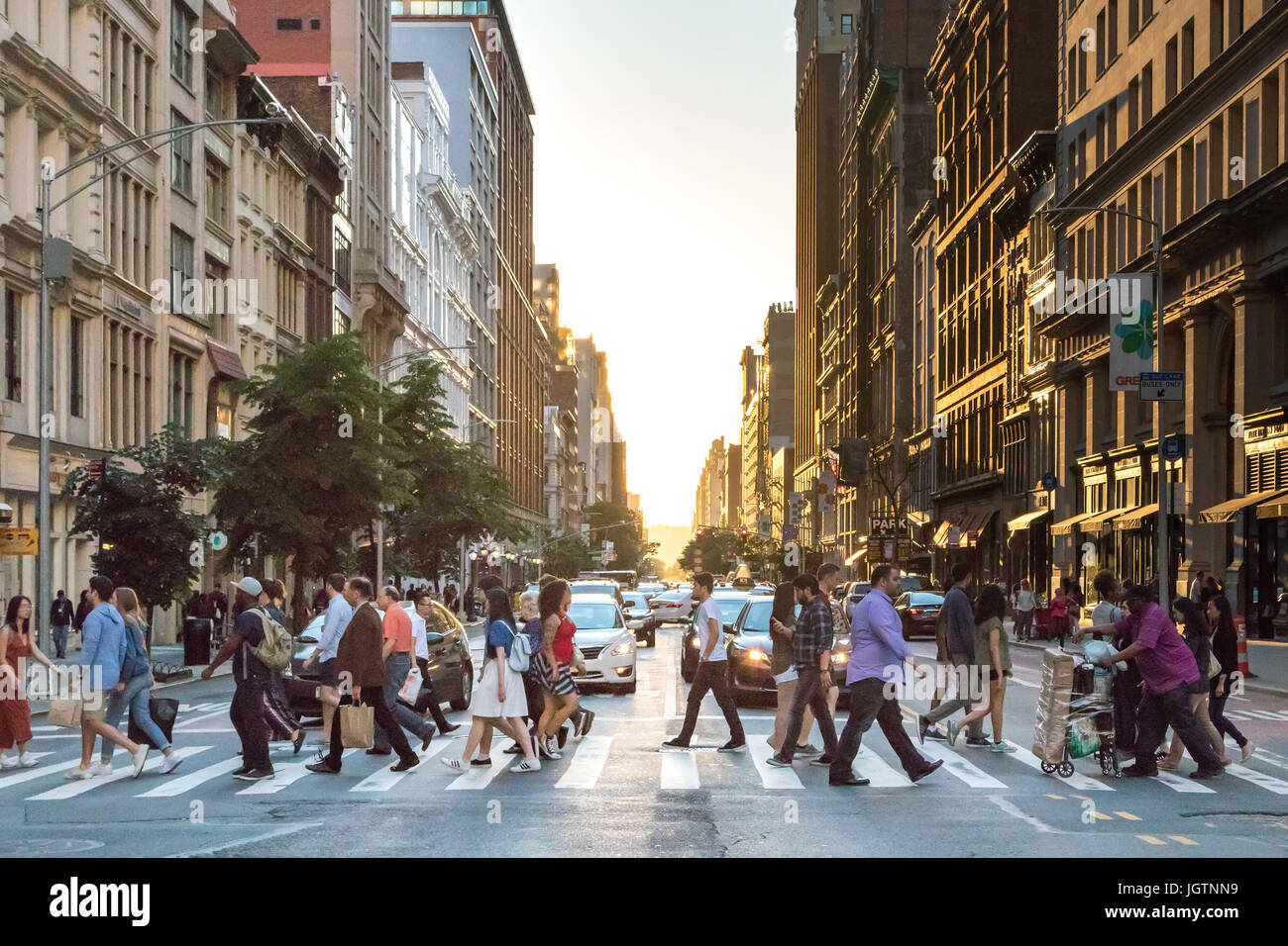 NEW YORK CITY - CIRCA 2017: Busy crowds of people cross the intersection of 5th Avenue and 23rd Street in Manhattan, New York City with the colorful s Stock Photo