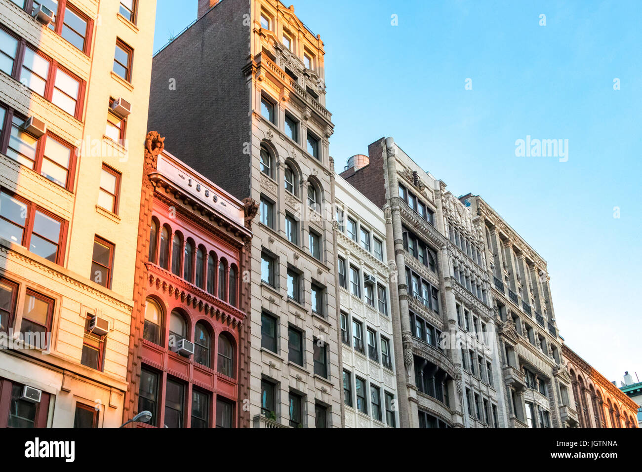 Row of tall historic buildings in the afternoon sunlight along Broadway in Manhattan, New York City NYC Stock Photo