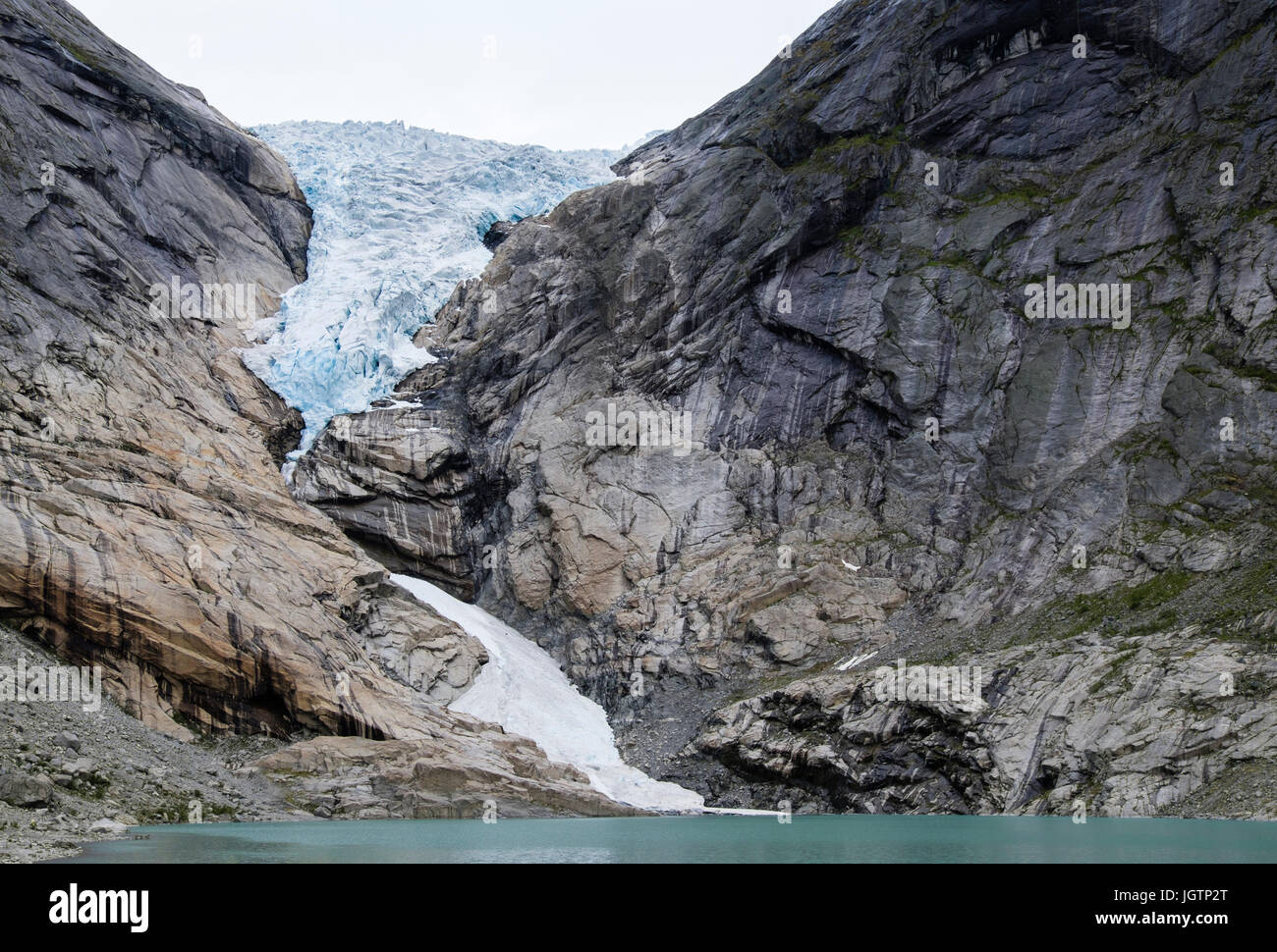 Briksdalsbreen or Briksdal glacier is an arm of Jostedalsbreen glacier above Briksdalsbrevatnet glacial lake in Jostedalsbreen National Park Norway Stock Photo