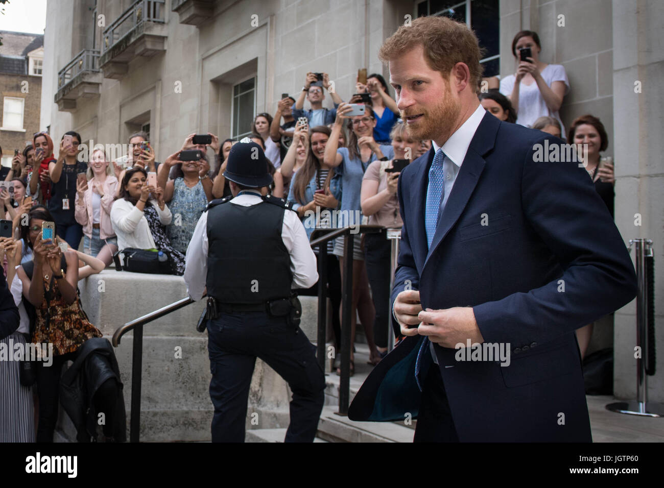 Prince Harry is photographed by members of the public as he leaves the London School of Hygiene and Tropical Medicine in Bloomsbury, London where he saw the work being undertaken to combat some of the world's most pressing health issues. Stock Photo
