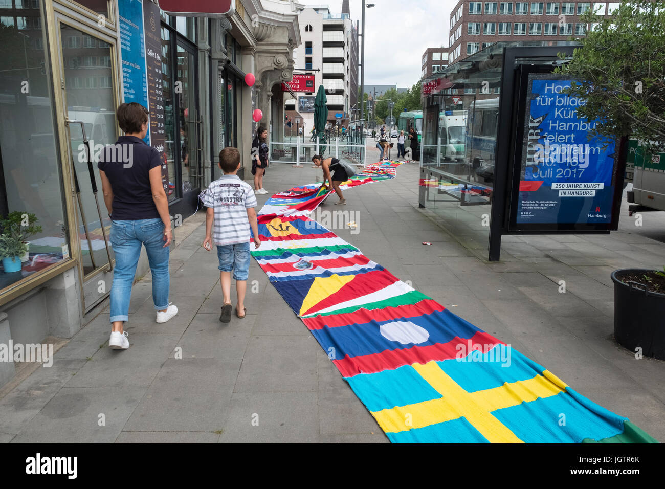 8th July, 2017. Hamburg, Germany. Many country flags stitched together and placed on road during G20 summit in Hamburg Stock Photo