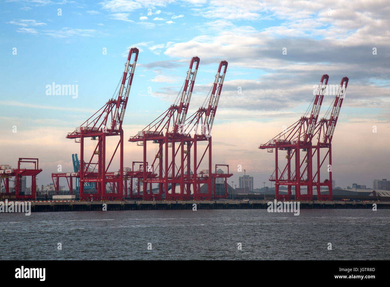 Large cranes at the mouth of The River Mersey, entering Liverpool in England. Stock Photo