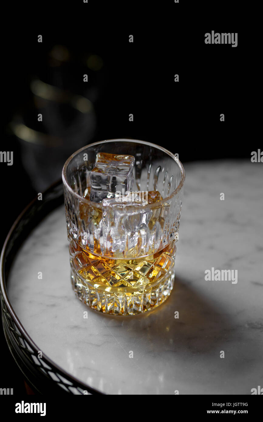 Cognac in a tumbler on a table Stock Photo