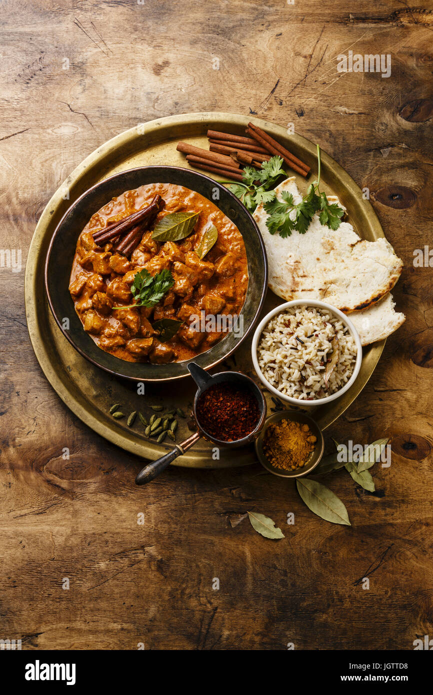 Chicken tikka masala spicy curry meat food in copper pan with rice and ...