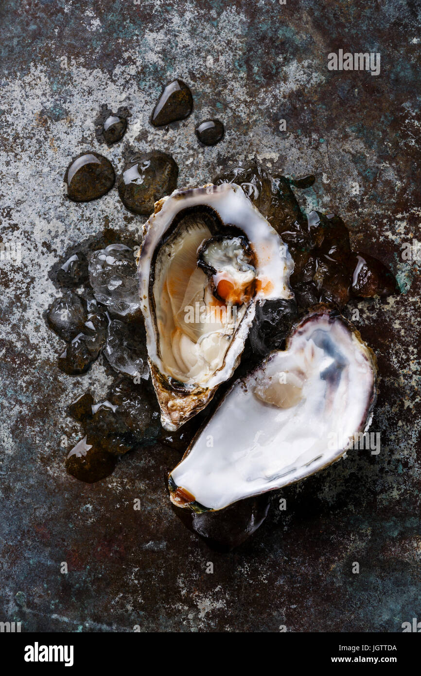 Open Oyster heart shape on ice with spicy sauce on metal background Stock Photo Alamy