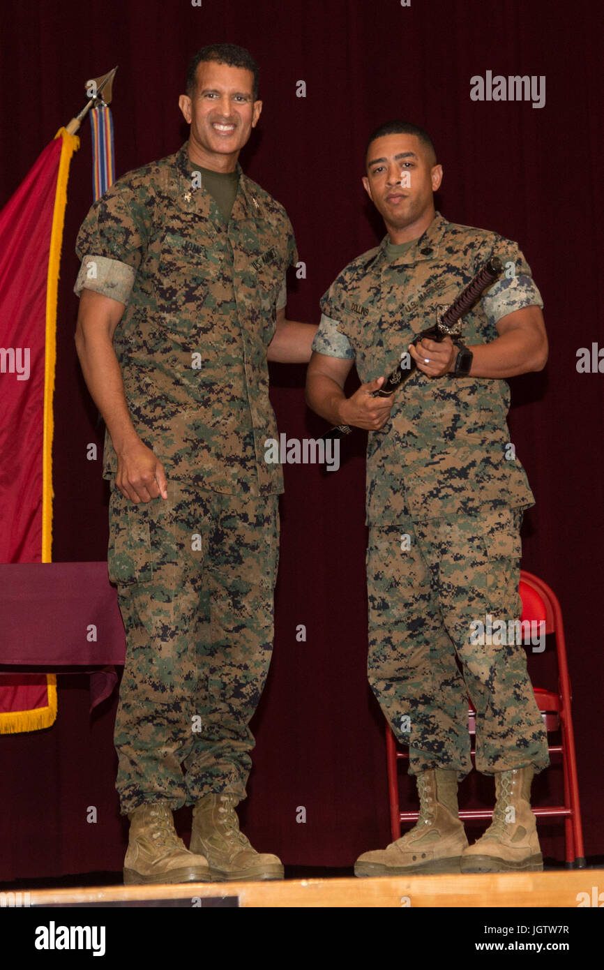 U.S. Marine Corps 1st Sgt. Michael Collins, a Headquarters Battery first sergeant with 3rd Battalion 12th Marines, Headquarters Battery, poses for a picture after receiving an award at a 2017 Navy-Marine Corps Relief Society (NMCRS) Active Duty Fund Drive during an award ceremony at the Camp Foster Community Center, Camp Foster, Okinawa, Japan, July 6, 2017. The NMCRS provided financial relief to active duty and retired Marines and Sailors as well as their eligible surviving family members through interest-free loans and grants. (U.S. Marine Corps photo by MCIPAC Combat Camera Lance Cpl. Chris Stock Photo