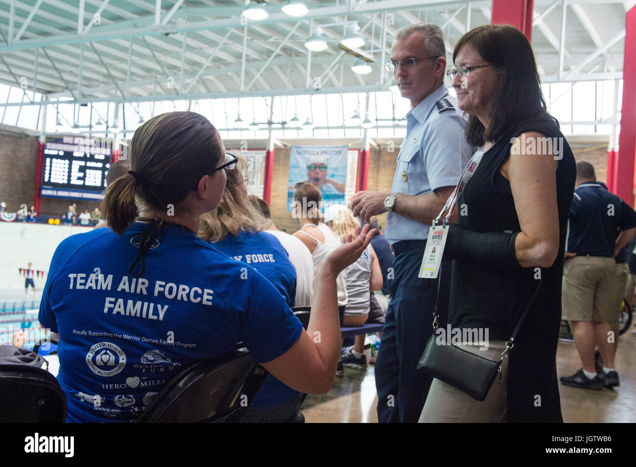Mrs. Ricki Selva, right, wife of U.S. Air Force Gen. Paul J. Selva, Vice Chairman of the Joint Chiefs of Staff, center, speaks with a Team Air Force family member during the swimming competition of the 2017 Department of Defense (DoD) Warrior Games at the University of Illinois, Chicago, Ill., July 8, 2017. The DoD Warrior Games are an annual event allowing wounded, ill and injured service members and veterans to compete in Paralympic-style sports. (DoD Photo by U.S. Army Sgt. James K. McCann) Stock Photo