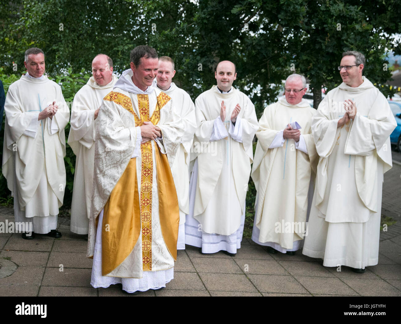 Former Manchester United player Philip Mulryne is applauded by other  Priests and Brothers after his inaugural mass at St Oliver Plunkett Church  in West Belfast following his ordination Stock Photo - Alamy