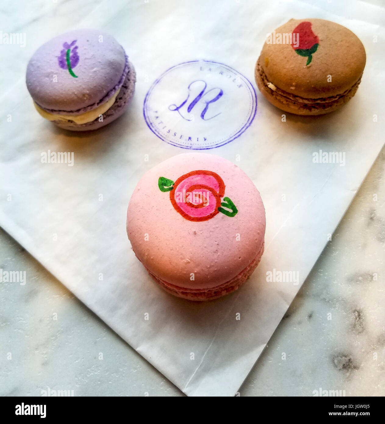 Three 'macarons' (meringue filled with cream) sold at La Roux Patisserie in Victoria's Chinatown. Vancouver Island, BC, Canada. Stock Photo