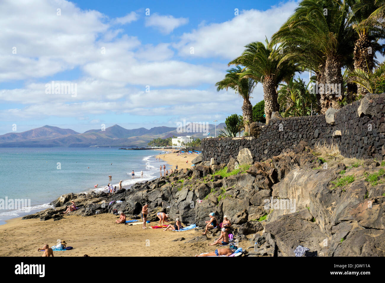 People at beaches between lava rocks, Puerto del Carmen, Lanzarote island, Canary islands, Spain, Europe Stock Photo