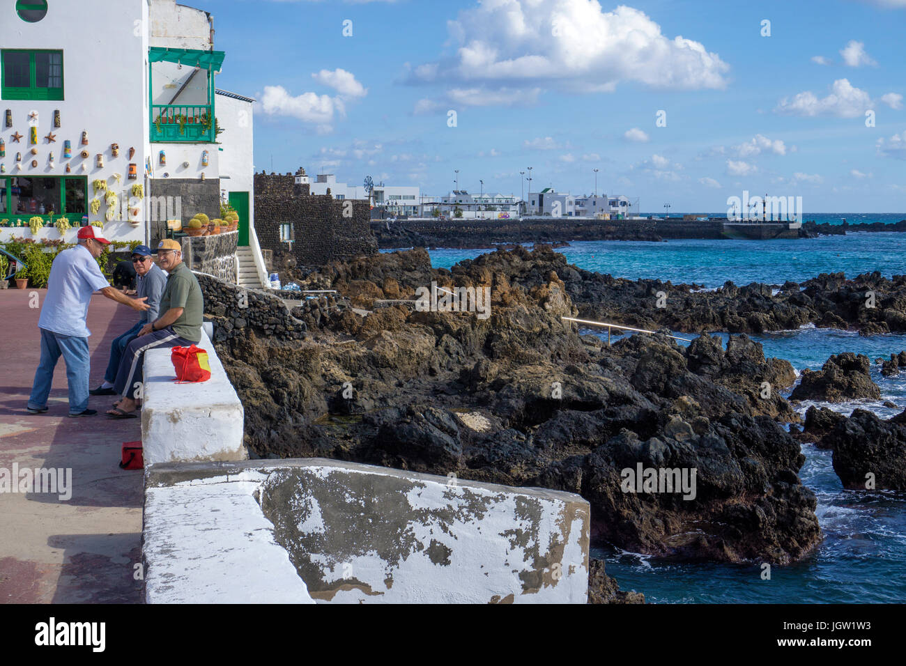 Elderlies at the coast, Punta Mujeres, fishing village north of Lanzarote, Canary islands, Europe Stock Photo