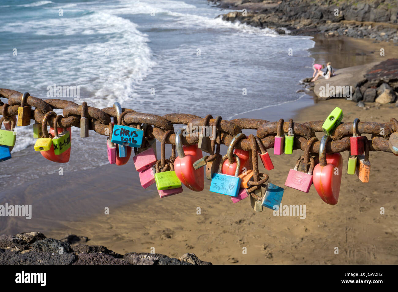 Love lockers hanging on chain at Playa Grande, large beach at Puerto del Carmen, Lanzarote island, Canary islands, Spain, Europe Stock Photo