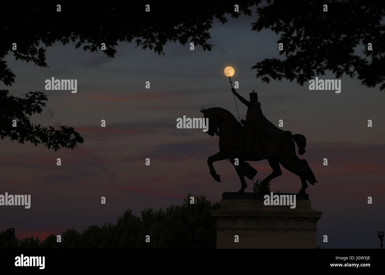 The moon over the Apotheosis of St. Louis statue of King Louis IX of France, namesake of St. Louis, Missouri in Forest Park, St. Louis, Missouri. Stock Photo