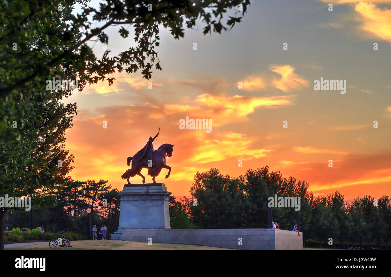 The sunset over the Apotheosis of St. Louis statue of King Louis IX of France, namesake of St. Louis, Missouri in Forest Park, St. Louis, Missouri. Stock Photo