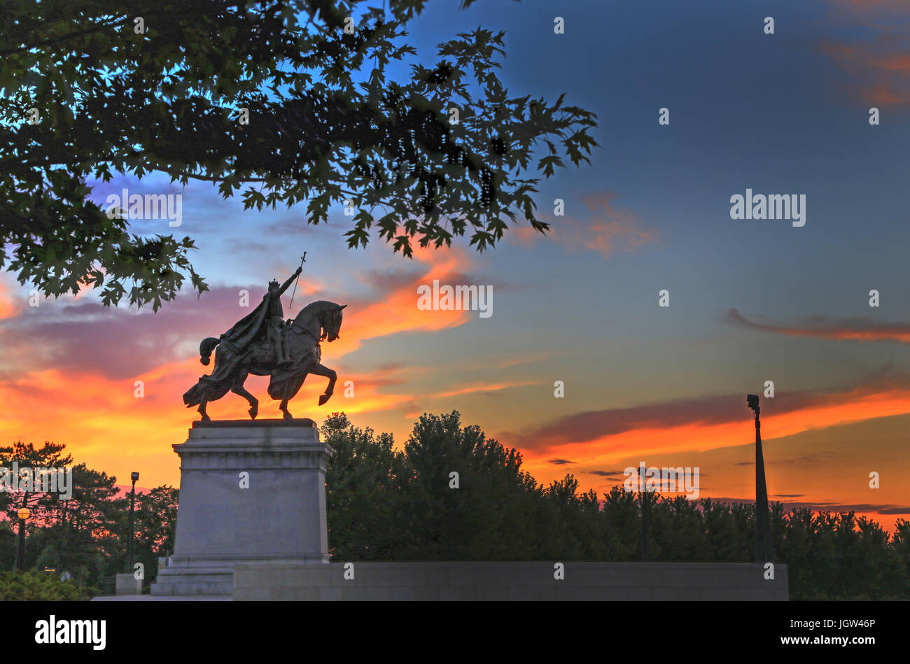 The sunset over the Apotheosis of St. Louis statue of King Louis IX of France, namesake of St. Louis, Missouri in Forest Park, St. Louis, Missouri. Stock Photo