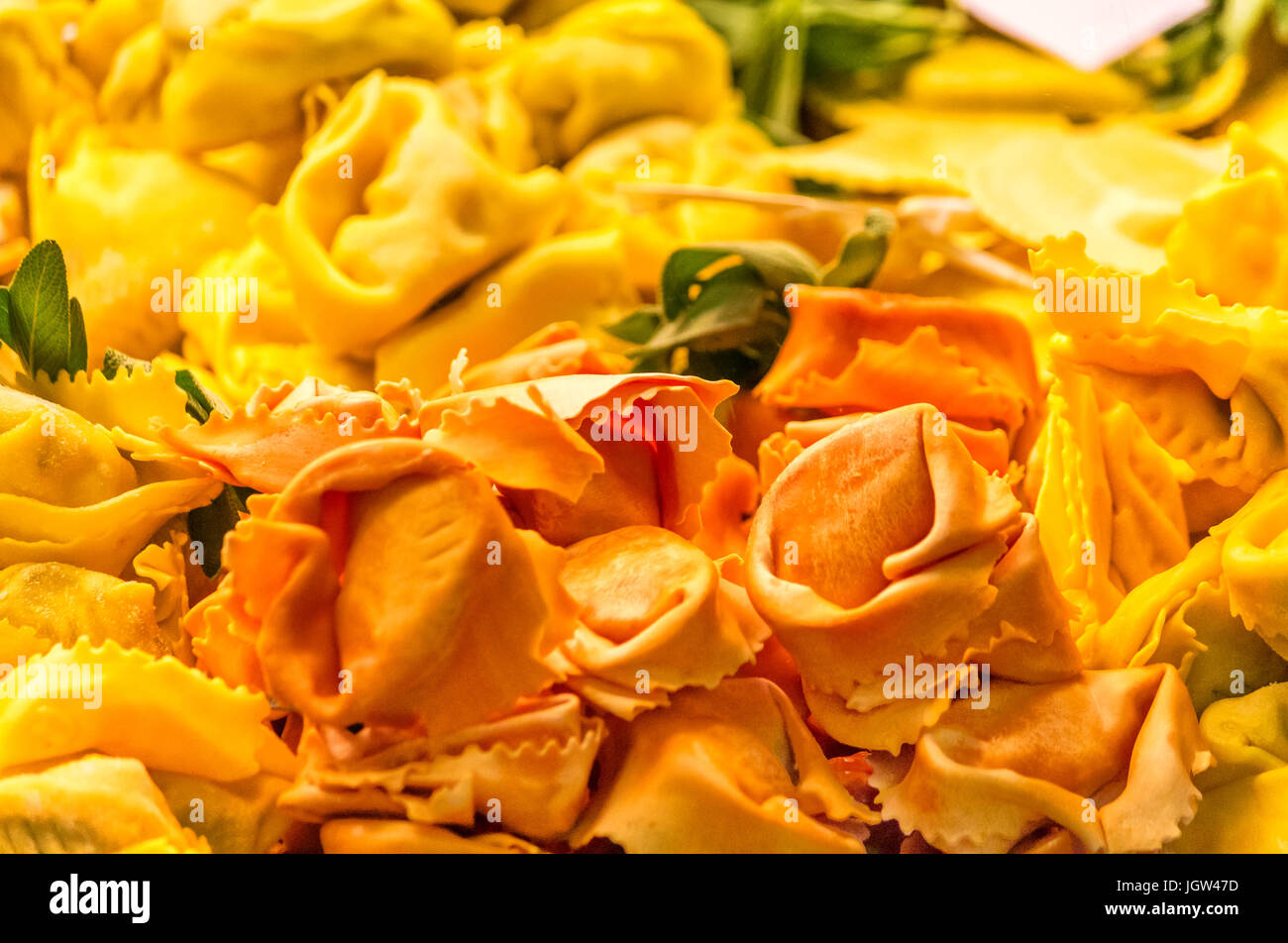 Italian homemade orange and yellow tortellini cappelletti Stock Photo