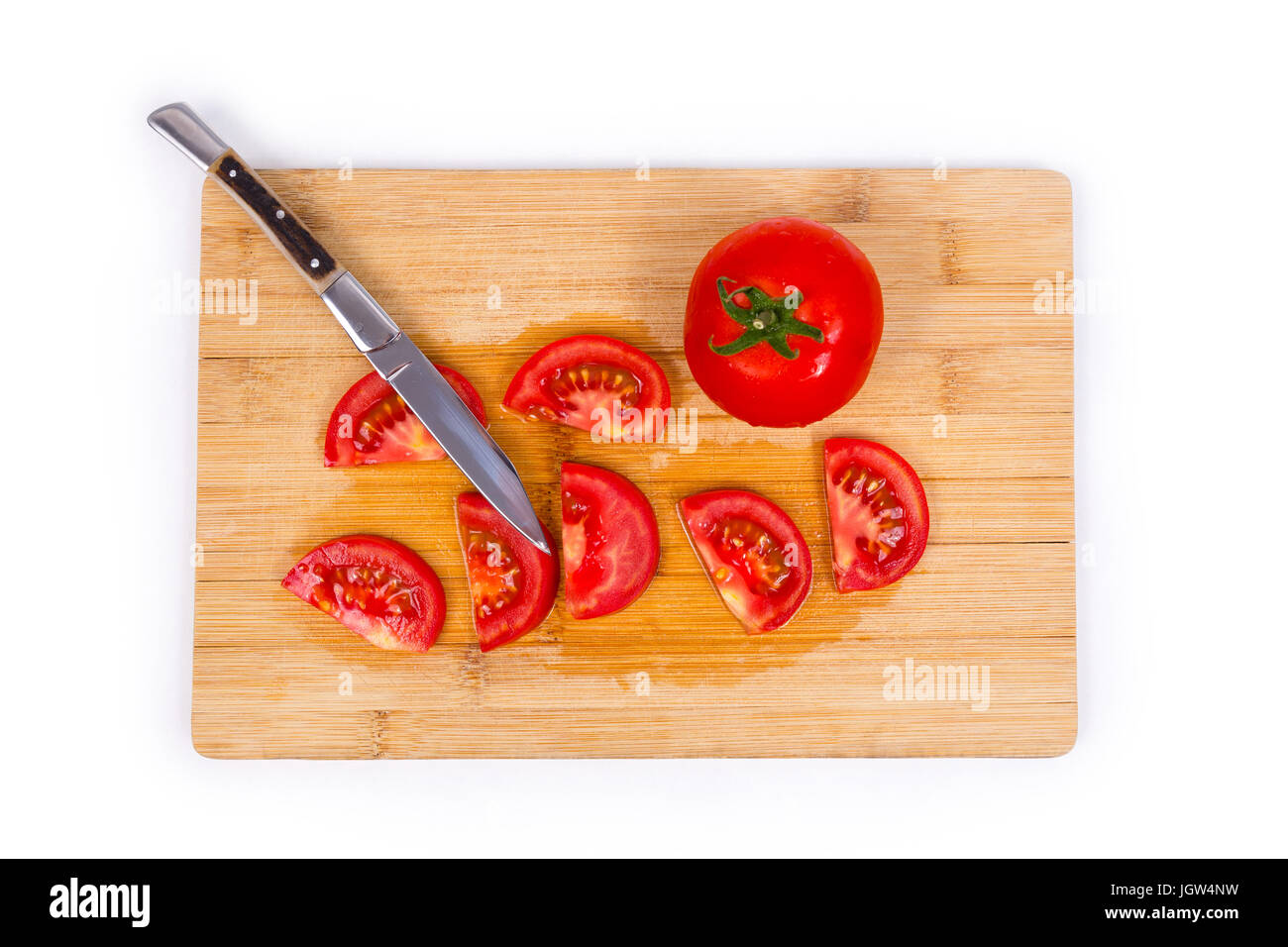 Tomato on cutting board with pocket knife Stock Photo - Alamy