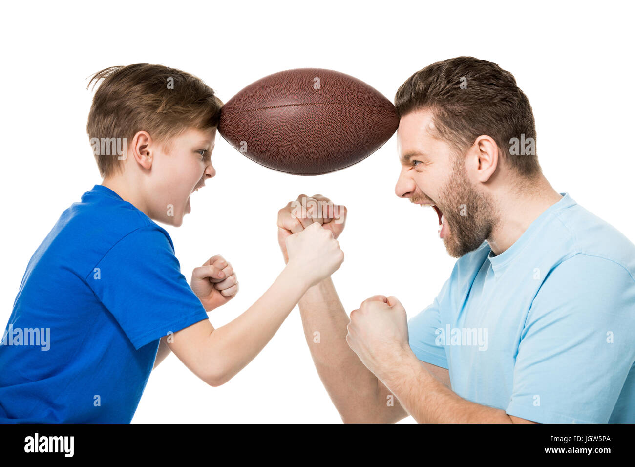 Side view of father with son screaming and holding rugby ball between faces isolated on white Stock Photo