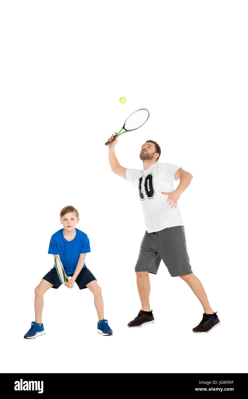 active father and son playing tennis together isolated on white Stock