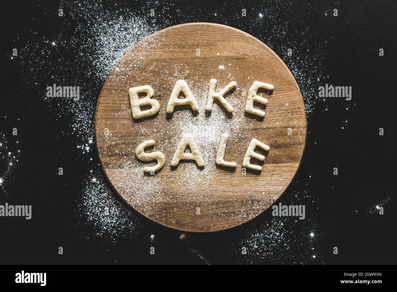 top view of cookies in forms of letters with powdered sugar, cookie dough Stock Photo
