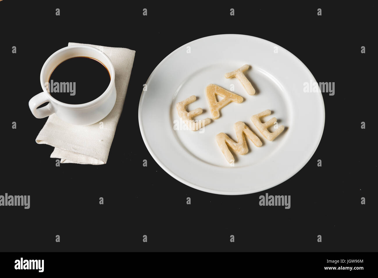 top view of eat me lettering made from cookie dough on plate with ...