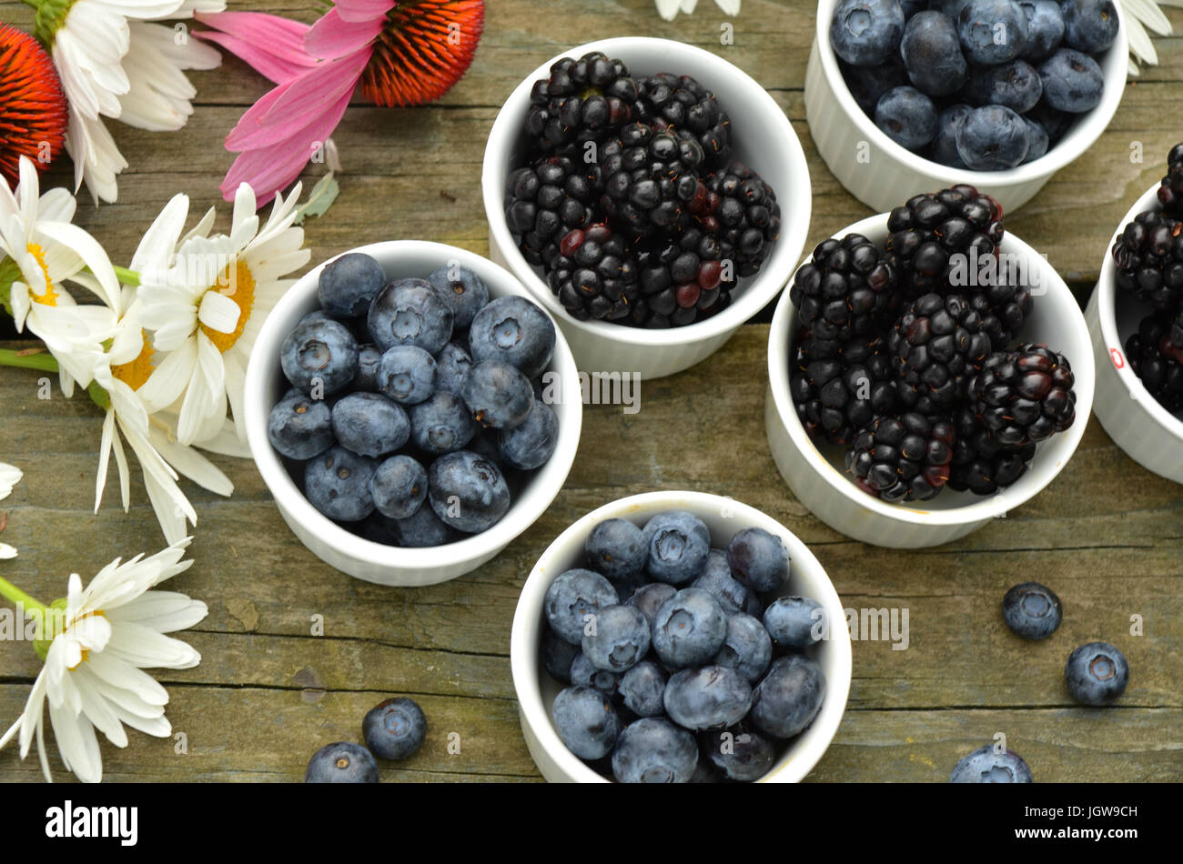 blueberries and blackberries in small white ramekin portions with ...