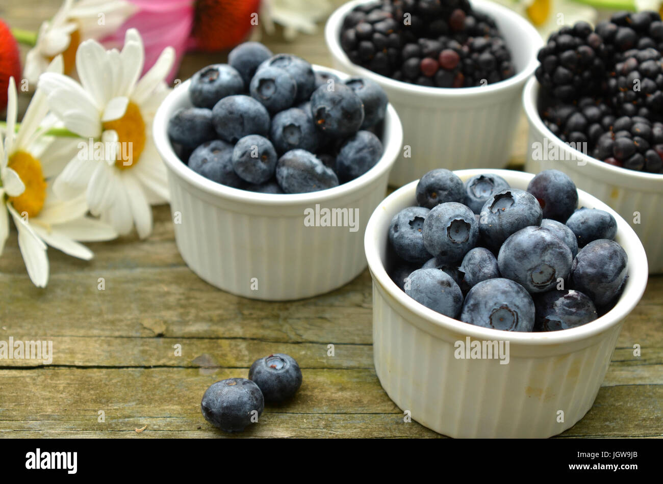 blueberries and blackberries in small white ramekin portions with ...