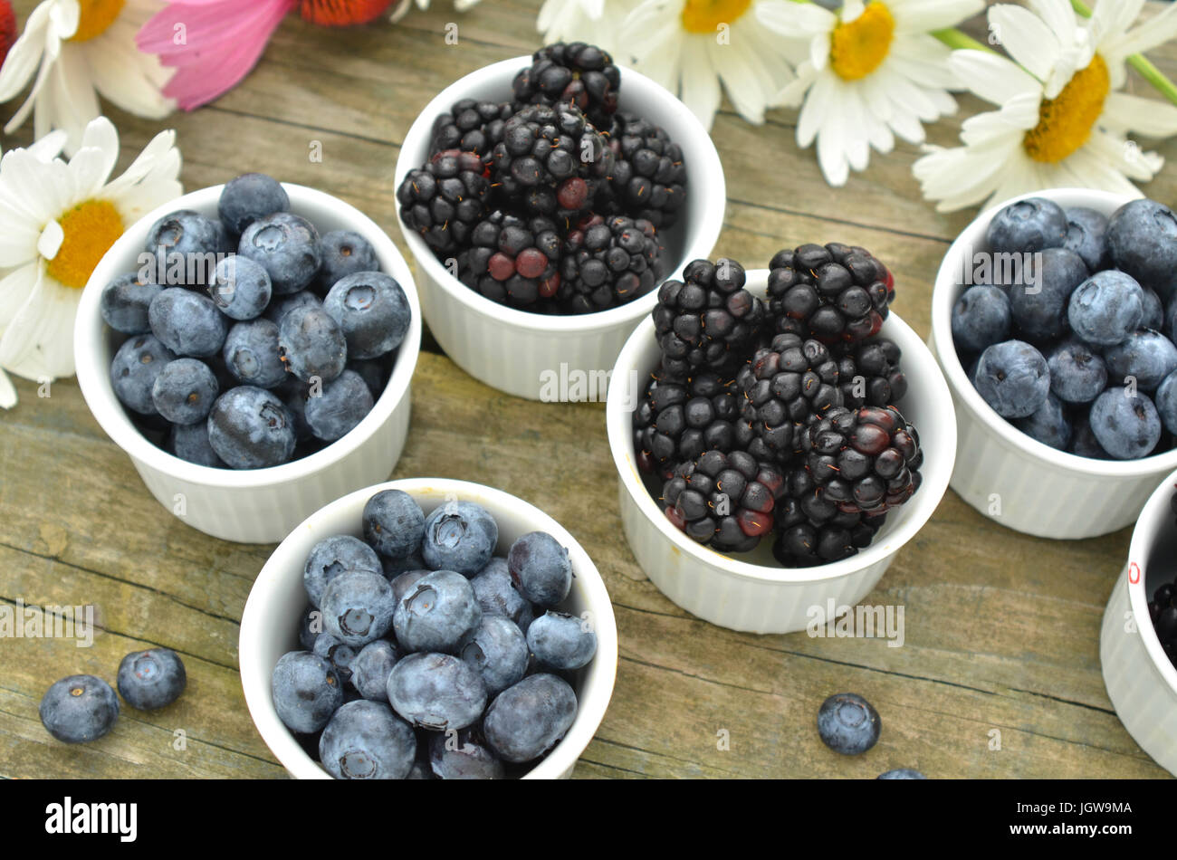 blueberries and blackberries in small white ramekin portions with ...